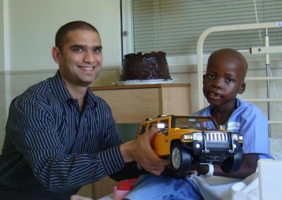 Ismail presenting a seriously ill child with a remote controlled car